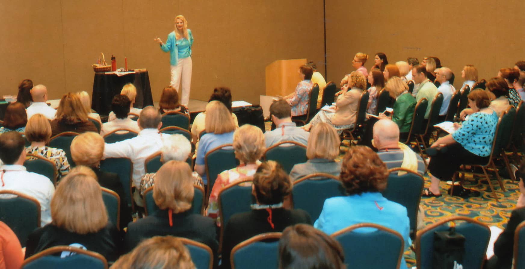 Snowden McFall presenting to a large audience